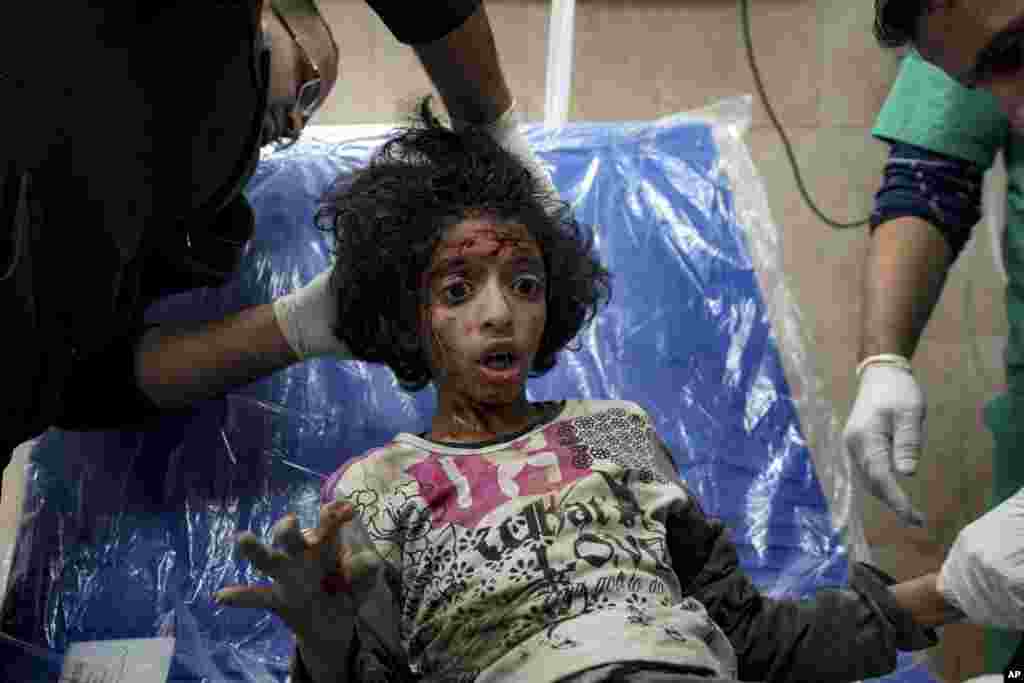 A Palestinian child wounded during the Israeli bombardment of the Gaza Strip receives treatment at the Al-Aqsa Hospital in Deir al-Balah.