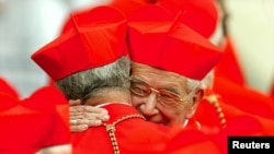 Cardinal Rodolfo Quezada Toruno (R) of Guatemala hugs a colleague during the consistory led by Pope John Paul II in Saint Peter's Square at the Vatican (2003 File).