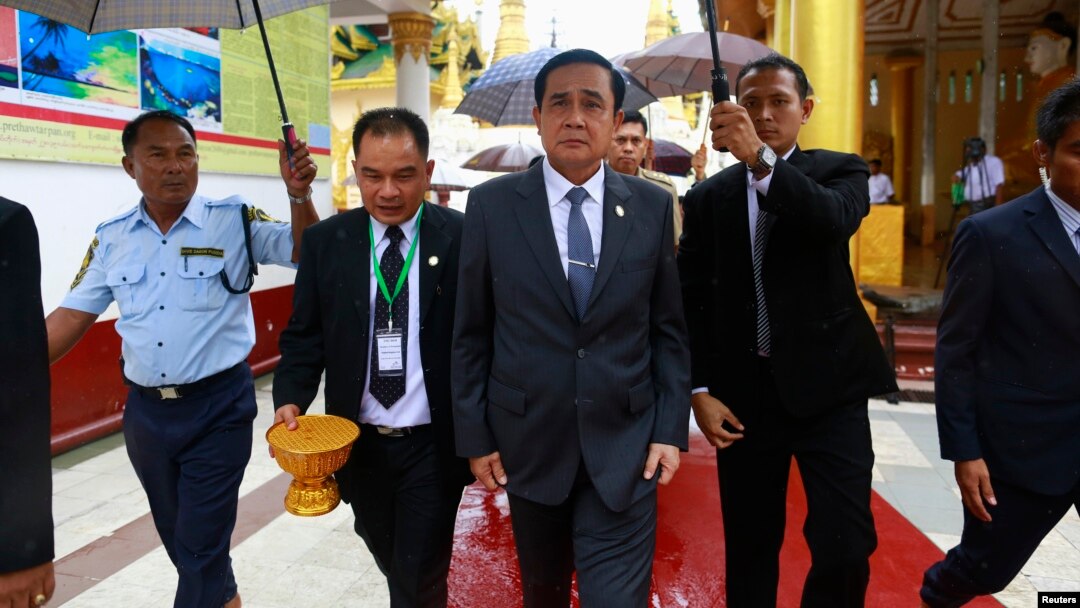 Thailand's Prime Minister Prayuth Chan-ocha, center, tours Shwedagon Pagoda on first official visit to Myanmar, also known as Burma, Oct. 10, 2014.