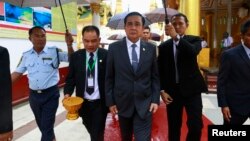 Thailand's Prime Minister Prayuth Chan-ocha, center, tours Shwedagon Pagoda on first official visit to Myanmar, also known as Burma, Oct. 10, 2014.