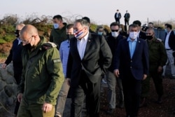 U.S. Secretary of State Mike Pompeo is accompanied by Israeli Foreign Minister Gabi Ashkenazi as they arrive for a security briefing on Mount Bental in the Israeli-occupied Golan Heights, Nov. 19, 2020.