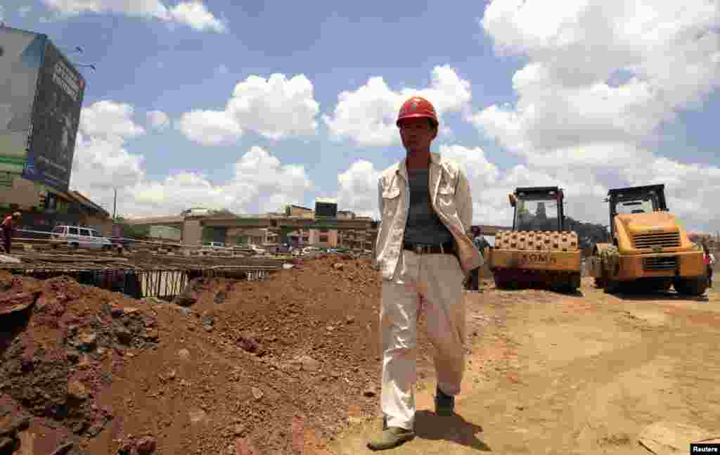 A site manager from China Wuyi, Sinohydro and Shengeli Engineering Construction Group checks progress on Kenya’s Nairobi-Thika highway project in 2011. The $28 billion road is paid for by China, Kenya and the African Development Bank.