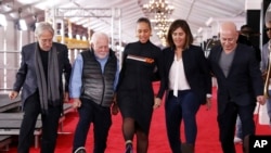 FILE - (L-R) Recording Academy pres. Neil Portnow, exec. producer Ken Erhlich, host Alicia Keys, producer Chantel Sausedo, and CBS' Jack Sussman, Exec. VP, Specials, Music, and Live Events, roll out the Grammy Awards red carpet, Feb. 7, 2019, Los Angeles.