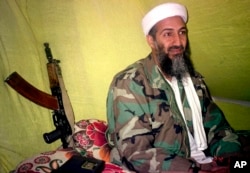 FILE - Then-al-Qaida leader Osama Bin Laden speaks to a select group of reporters in mountains of Helmand province in southern Afghanistan, Dec. 24, 1998.