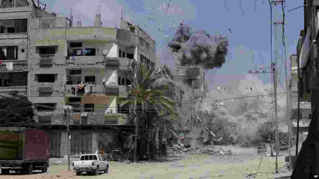 Smoke and dust rise after an Israeli strike on a three-story building belonging to the Abdul Hadi family in Gaza City in the northern Gaza Strip, Aug. 24, 2014. 