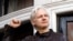 FILE - In this May 19, 2017 photo, WikiLeaks founder Julian Assange greets supporters outside the Ecuadorian embassy in London, where he has been in self imposed exile since 2012. 