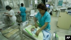 FILE - Nurses attend newborn babies at the Maternity hospital in Lima, Peru.