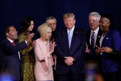 FILE - Faith leaders pray with President Donald Trump during a rally for evangelical supporters at the King Jesus International Ministry church, Jan. 3, 2020, in Miami.