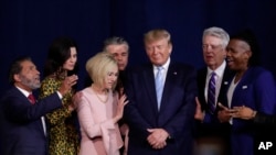 Faith leaders pray with President Donald Trump during a rally for evangelical supporters at the King Jesus International Ministry church, Jan. 3, 2020, in Miami.