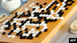 FILE - For the first time, a computer defeated a professional human being in Go, a complex game using black and white pieces on a square grid. 
