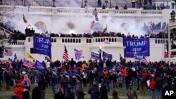 FILE - Protesters loyal to then-President Donald Trump storm the Capitol, Jan. 6, 2021. 