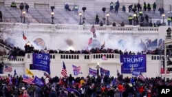 FILE - Protesters loyal to then-President Donald Trump storm the Capitol, Jan. 6, 2021. 