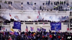 FILE - Protesters loyal to then-President Donald Trump storm the Capitol, Jan. 6, 2021.