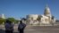 Police stand guard near the National Capitol building in Havana, Cuba, Monday, July 12, 2021, the day after protests against food shortages and high prices amid the coronavirus crisis.