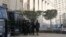 FILE - Riot police stand guard in front of an appeals court in Cairo.