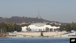 FILE - Australia's Parliament House sits behind Lake Burley Griffin in Canberra, Australia, Thursday, April 24, 2008. 