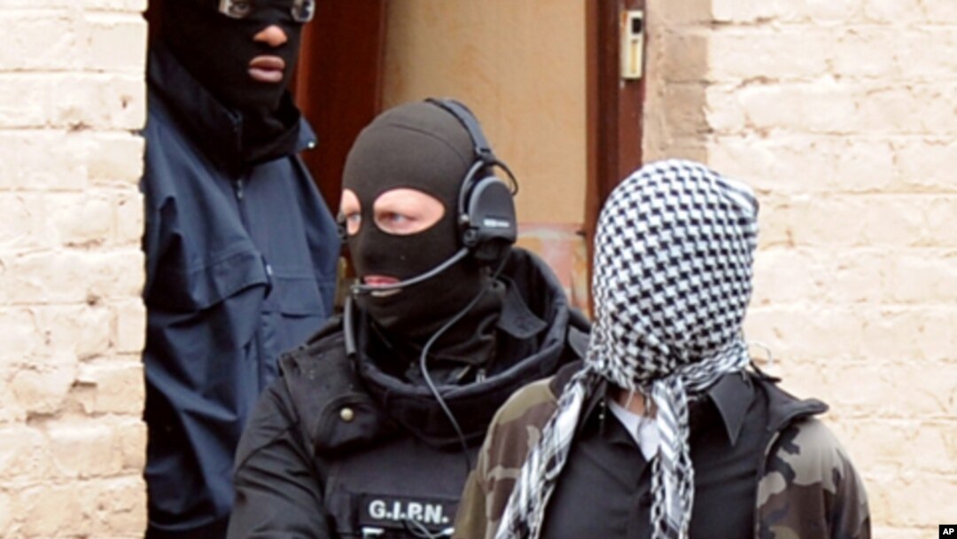 French members of the French National Police Intervention Group (GIPN) arrest a suspected radical Islamist group member, on April 4, 2012, in Roubaix.