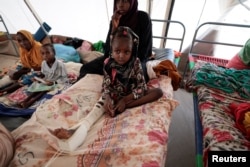 FILE - Nussayba Mohammed Adam, 6, a Sudanese girl who was hit by a car driven by Rapid Support Forces (RSF) as she fled the conflict in Geneina in Sudan's Darfur region, receives treatment at a Medecins Sans Frontieres (MSF) mission hospital in Adre, Chad July 23, 2023.