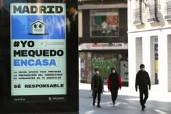 A billboard advising people to be responsible and stay home is seen at the almost empty Preciados Street, due to the coronavirus outbreak, in central Madrid, Spain, March 14, 2020.