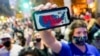 A supporter of President-elect Joe Biden holds up his mobile phone to display the electoral college map outside the Philadelphia Convention Center after the 2020 Presidential Election is called, Nov. 7, 2020. 