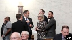 West Virginia state Rep. Kayla Young, D-Kanawha, speaks with colleagues in the House Chambers at the Capitol in Charleston, W.Va., on Jan. 25, 2024. 