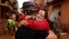 A member of Spain's Military Emergency Unit embraces with a local woman, in the aftermath of floods caused by heavy rains, in Sedavi, near Valencia, Spain, November 3, 2024. 