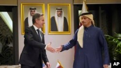 FILE - US Secretary of State Antony Blinken, left, shakes hands with Qatar's Prime Minister and Foreign Affairs Minister Mohammed Bin Abdulrahman Al Thani, at Diwan Annex, in Doha, Qatar, February 6, 2024.