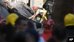 Rescue workers search for victims in the aftermath of an outdoor roof collapse at a train station in Novi Sad, Serbia, on Nov. 1, 2024.