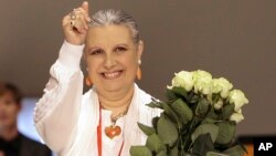 FILE - Italian Fashion designer Laura Biagiotti acknowledges the applause at the end of one of her shows in downtown Milan, Italy, June 24, 2007.