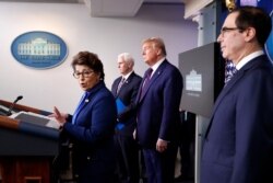 Jovita Carranza, administrator of the Small Business Administration, speaks about the coronavirus in the White House, April 2, 2020, as Vice President Mike Pence, President Donald Trump and Treasury Secretary Steven Mnuchin listen.