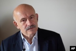 FILE - Pavel Palazhchenko, former chief interpreter for Soviet leader Mikhail Gorbachev, speaks during his interview to the Associated Press in Moscow, Russia, July 23, 2018.