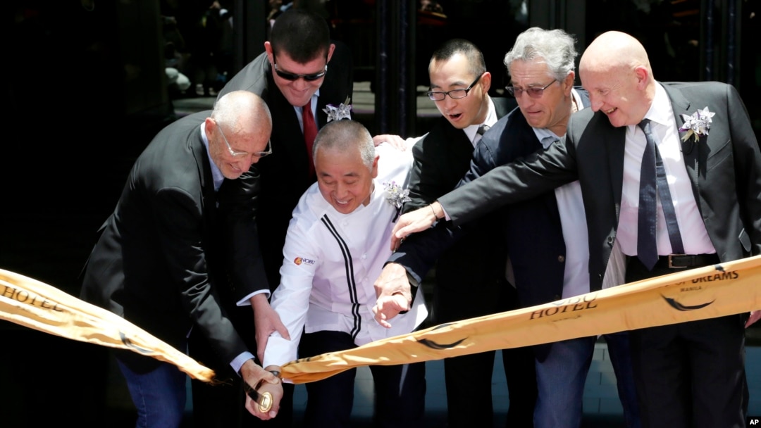 Hollywood actor Robert De Niro, second from right, joins his partners Japanese culinary Chef Nobu Matsuhisa, third from left, Hollywood film producer Meir Teper, left, and Melco Crown Entertainment casino executives James Packer, second from left, and Lawrence Ho, fourth from left, in ribbon-cutting ceremony at the opening of their Nobu Hotel at the City of Dreams Casino Monday, May 18, 2015 at suburban Pasay city, south of Manila, Philippines.