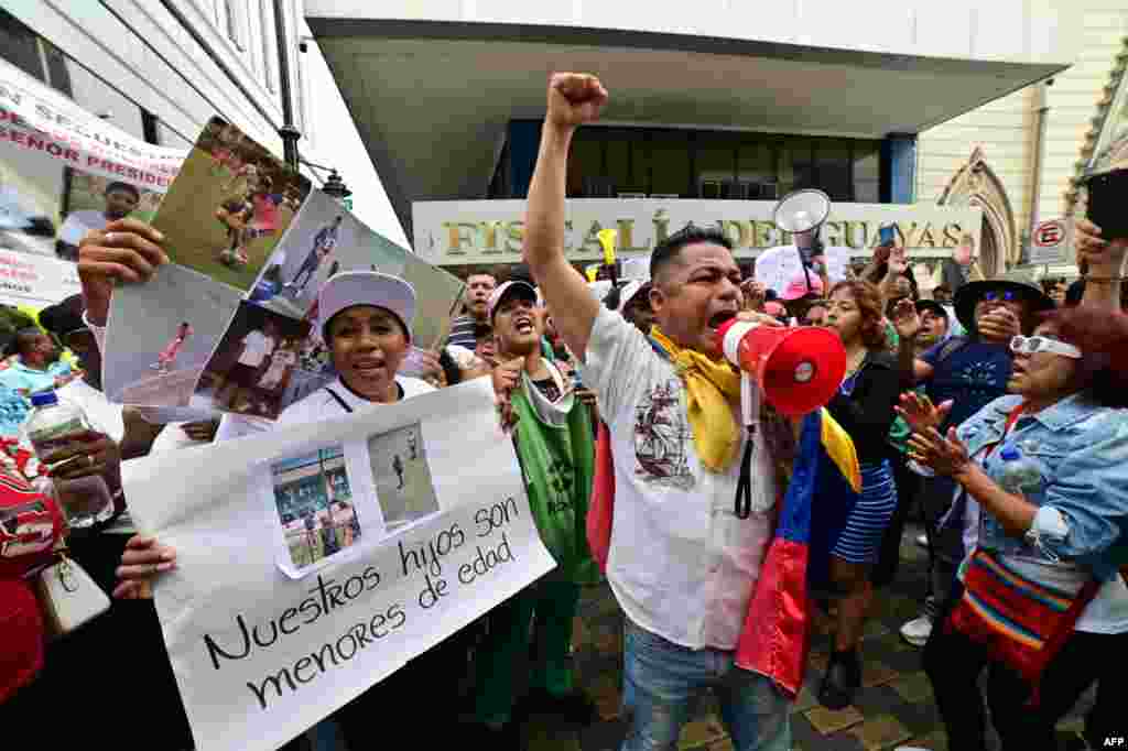 People demonstrate against the disappearance of four adolescent boys who went missing during a military operation two weeks ago while they were out playing football, in front of the prosecutor&#39;s office in Guayaquil, Ecuador.