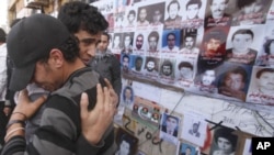 Mourners react during the funeral of relative who was killed in weapons dump attack in Benghazi, Libya, March 5, 2011