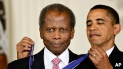 FILE - President Barack Obama presents the 2009 Presidential Medal of Freedom to Sidney Poitier during ceremonies in the East Room at the White House in Washington on, Aug. 12, 2009.