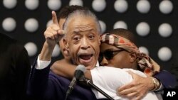 Rev. Al Sharpton, left, hugs Stevante Clark while speaking during the funeral services for police shooting victim Stephon Clark at Bayside Of South Sacramento Church in Sacramento, California, March 29, 2018. 