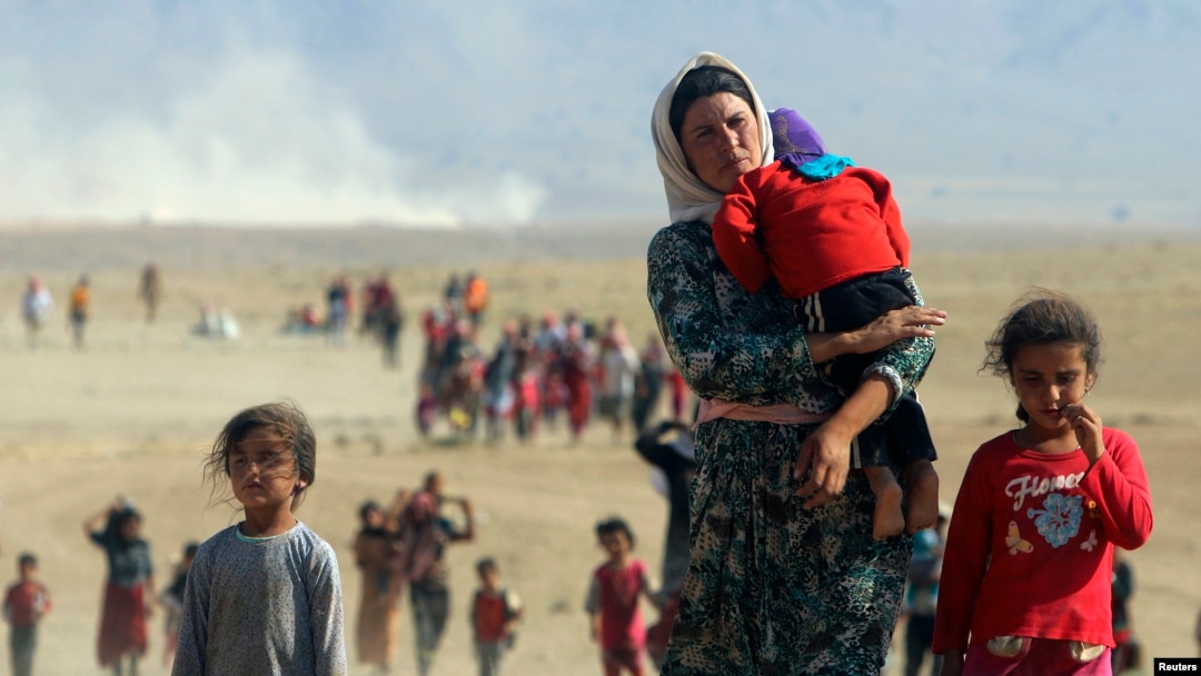 FILE - Displaced people from the minority Yazidi sect.