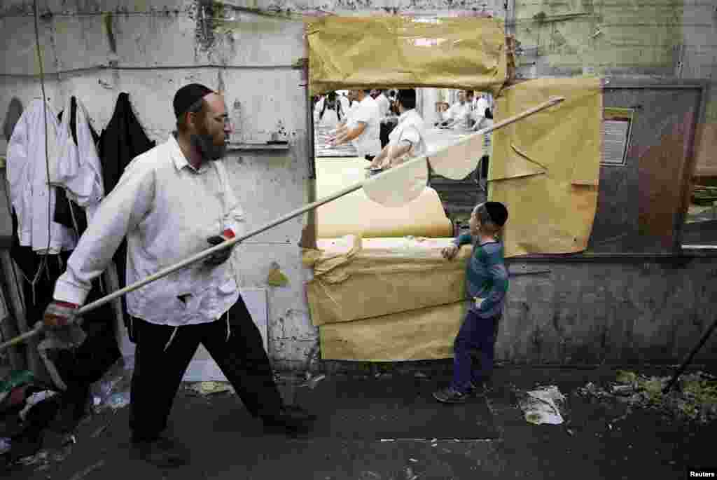 Ultra-Orthodox Jewish men prepare matza, traditional unleavened bread eaten during the upcoming Jewish holiday of Passover, in the southern city of Ashdod.