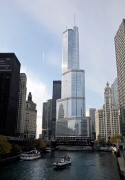 FILE - Boats move along the Chicago River near the Trump International Hotel and Tower, center, in Chicago, Nov. 8, 2013.