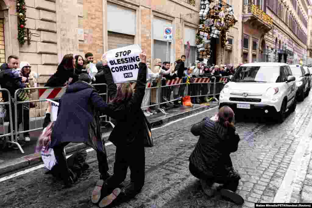 PETA activists interrupt the convoy of Pope Francis, ahead of Immaculate Conception celebration prayer, to stage a protest against bullfighting in Rome, Italy.