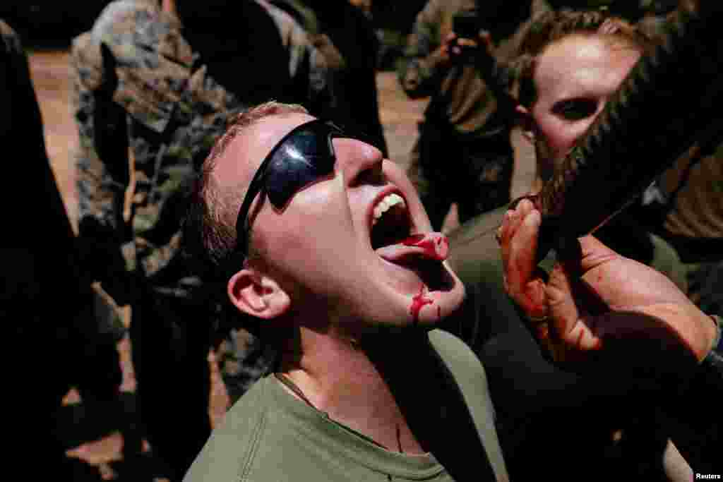 A U.S. soldier is fed snake blood during the Cobra Gold multilateral military exercise in Chonburi, Thailand.