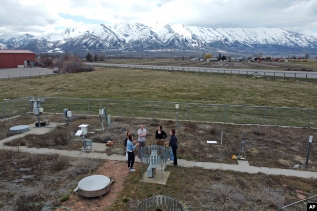 Climate Data Analyst Casey Olson, center left, of Utah State University stands with students during a tour of the climate reference station on April 1, 2024, in Logan, Utah. (AP Photo/Rick Bowmer)