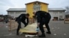 Police officers collect evidence at the site of a knife attack in which a man is suspected of killing one person and wounding two police officers in Mulhouse, France, on Feb. 22, 2025.