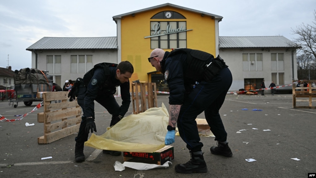 Police officers collect evidence at the site of a knife attack in which a man is suspected of killing one person and wounding two police officers in Mulhouse, France, on Feb. 22, 2025.