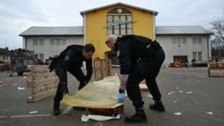 Police officers collect evidence at the site of a knife attack in which a man is suspected of killing one person and wounding two police officers in Mulhouse, France, on Feb. 22, 2025.