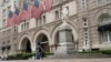 FILE - A man sits by the Old Post Office building on May 12, 2022, in Washington. The U.S. General Services Administration on March 5, 2025, took down a directory of federal property it had listed for possible sale, including the Old Post Office.