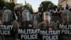 FILE - DC National Guard Military Police officers and law enforcement officers stand guard during a protest against the death in Minneapolis custody of George Floyd, near the White House in Washington.