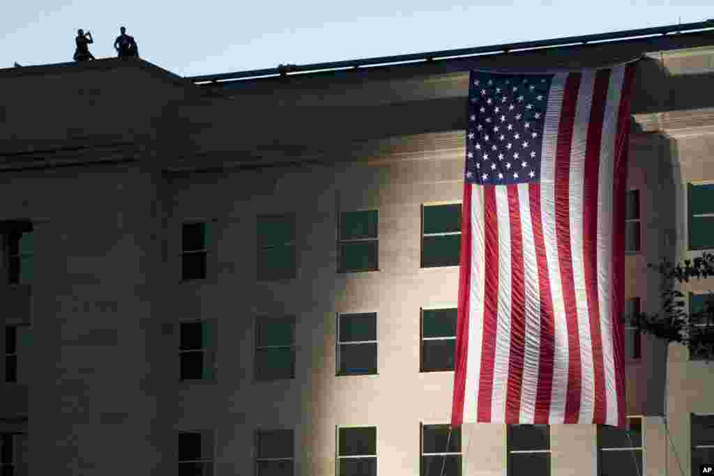 On the 14th anniversary of the attack, a U.S. flag is draped on the side of the Pentagon, Sept. 11, 2015, where the building was attacked on September 11th in 2001.