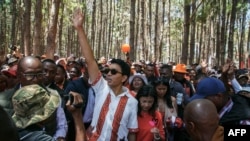 FILE - Incumbent Madagascar President Andry Rajoelina, greets supporters as he attends the first meeting of his electoral campaign, in Antananarivo, on October 10, 2023. 