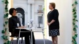 Chile&#39;s President Michelle Bachelet talks to a Geminoid HI-2 robot, which is made in likeness of its creator, Japanese professor Hiroshi Ishiguro (not pictured), during the opening ceremony of the Congress of the Future event in Santiago.